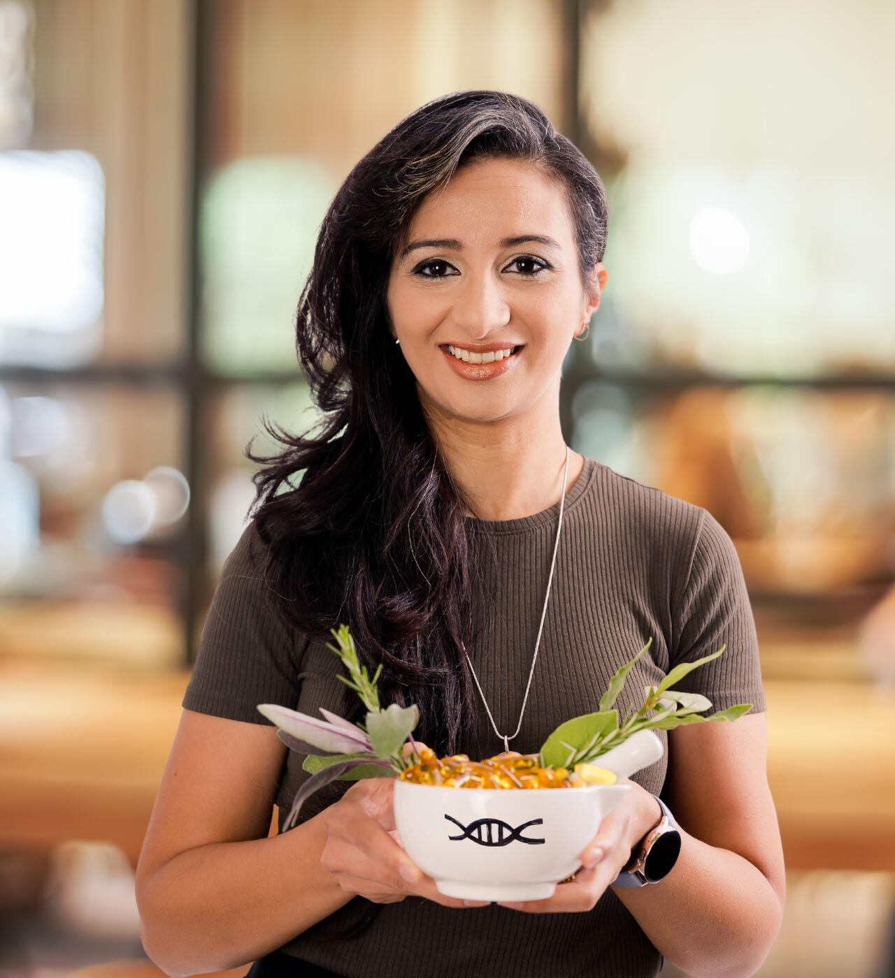 Picture of Australasian Precision Medicine Academy Founder, Katrina Azer, carrying mortar and pestle with DNa strand engraved on it